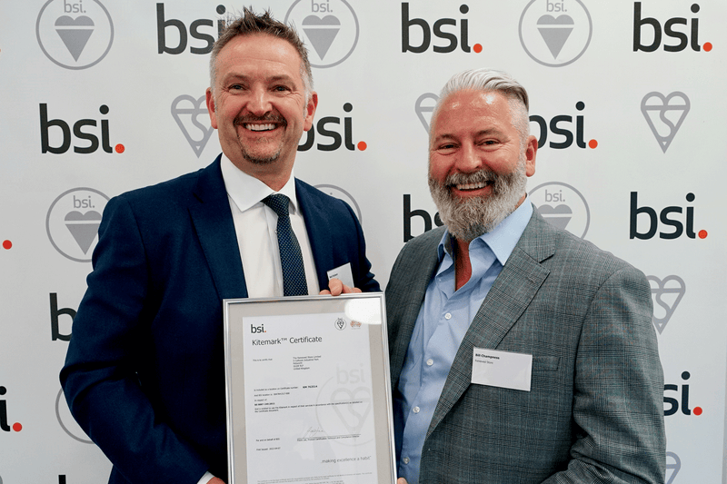 Neil Robson (left) and Bill Champness (right) receiving the BSI Certification for The Renewed Store